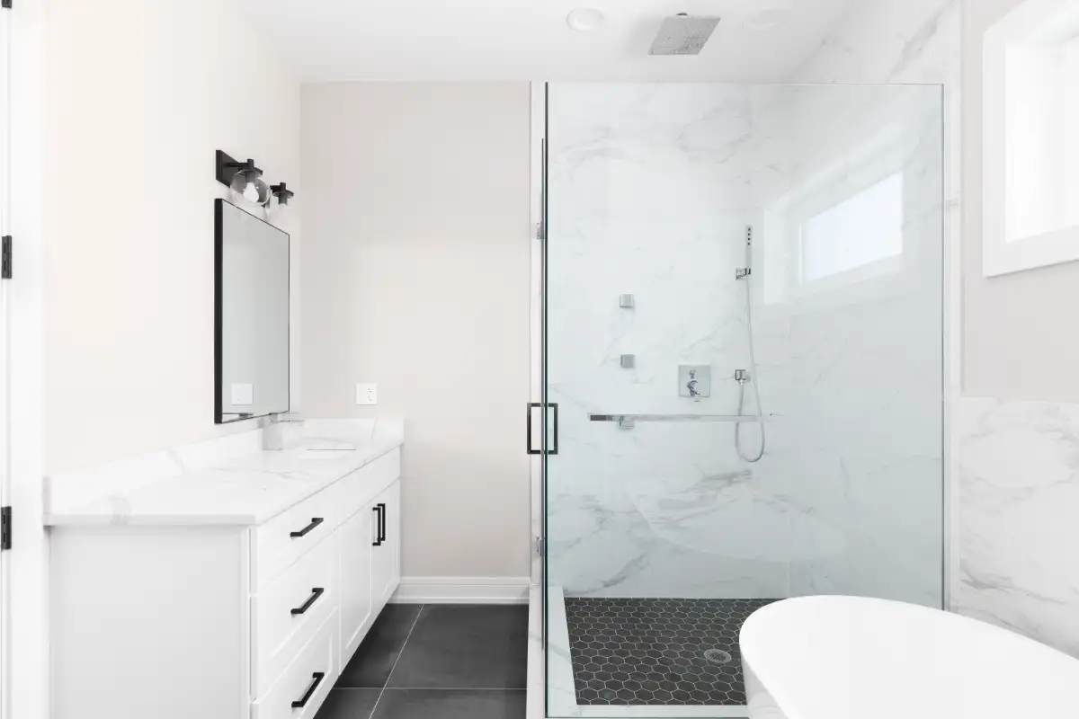 A Beautifully Renovated Bathroom With A White Vanity
