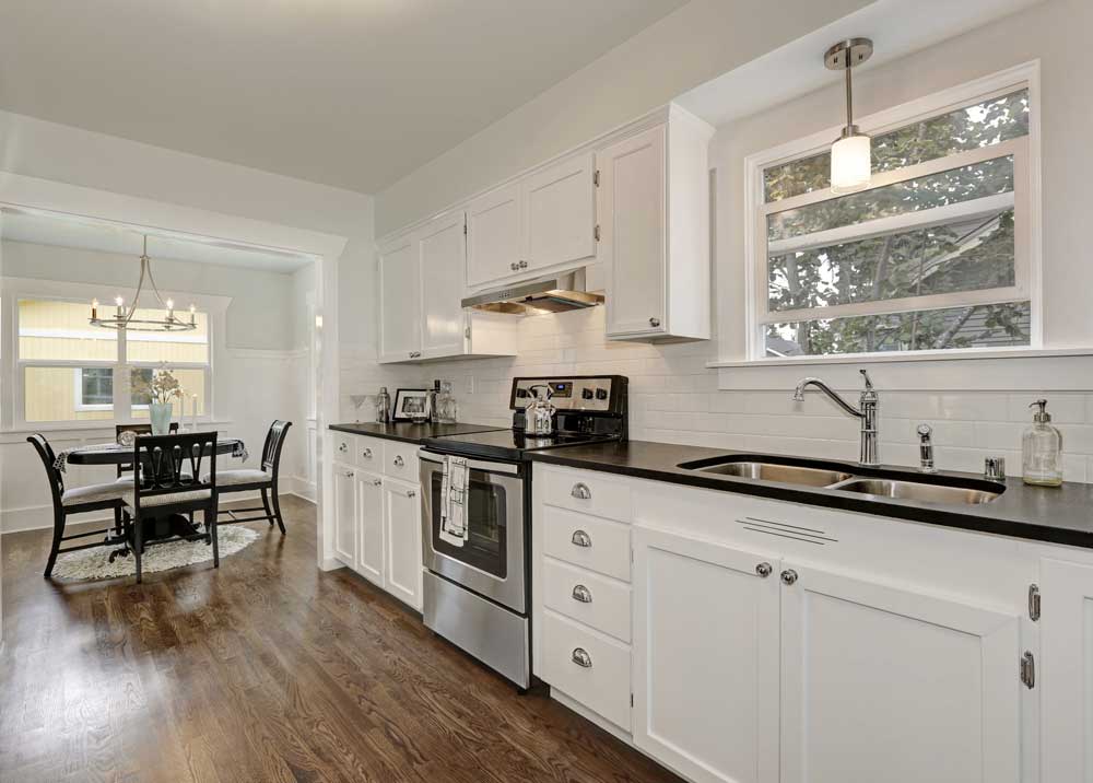Well-decorated white kitchen with modern cabinetry