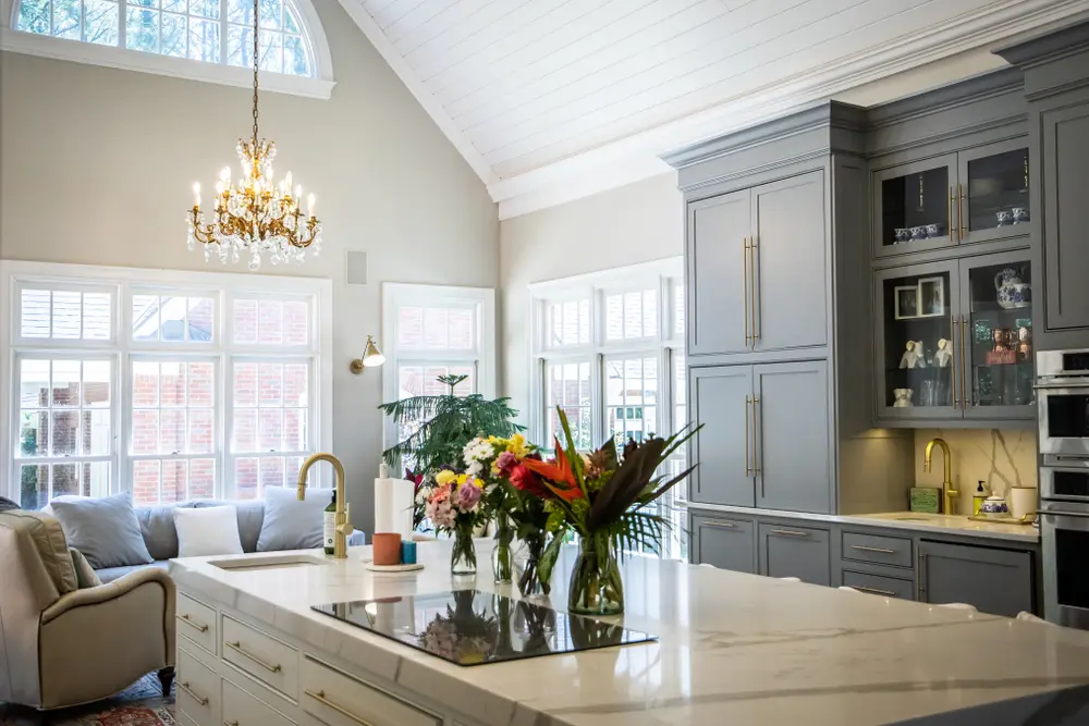Calabasas interior renovation with cream walls, gray cabinetry, and chandelier lighting